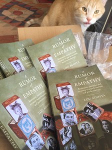 Paka, the cat, admires A Rumor of Empathy, cover art