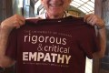Lou holding a rigorous and critical empathy t-shirt, compliment of Xavier Ramey and UChicago Community Outreach